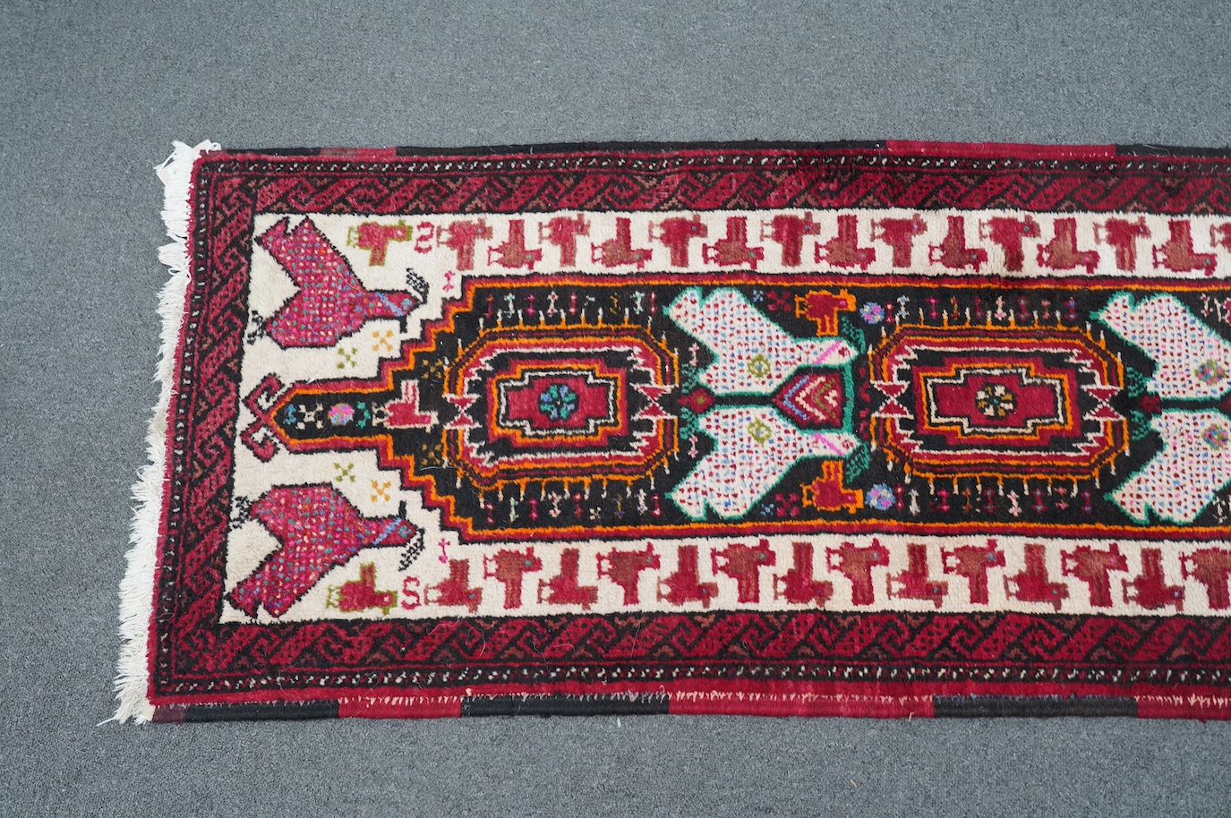 A Turkish red ground geometric runner, 266 x 63cm. Condition - good